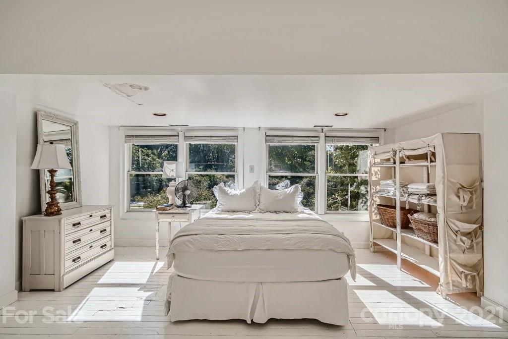 501 Marsh Road Charlotte, NC 28209 - Photo 18 of 27 a bedroom with a large bed and a window
