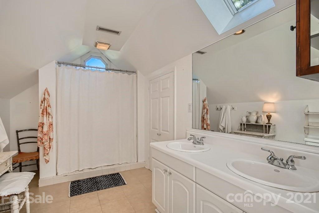 501 Marsh Road Charlotte, NC 28209 - Photo 19 of 27 a bathroom with a sink and a mirror