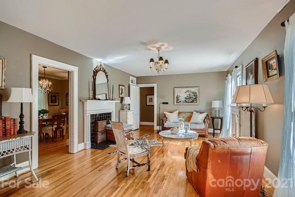 501 Marsh Road Charlotte, NC 28209 - Photo 7 of 27 a living room with furniture a fireplace and a piano