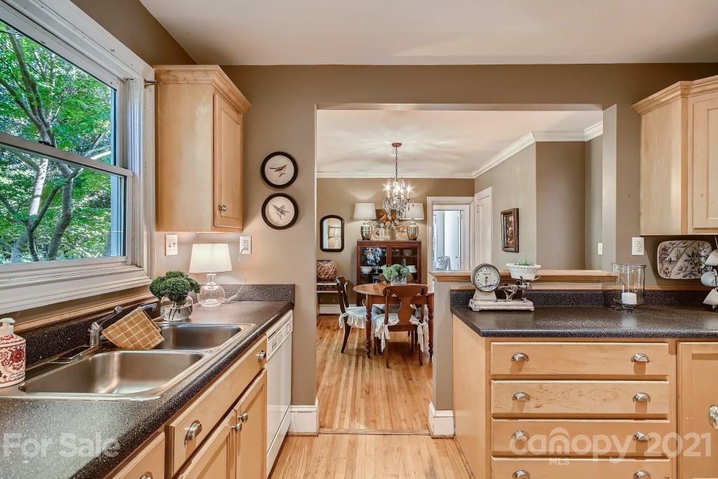 501 Marsh Road Charlotte, NC 28209 - Photo 9 of 27 a kitchen with sink refrigerator and large window