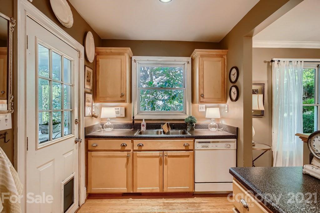 501 Marsh Road Charlotte, NC 28209 - Photo 10 of 27 a kitchen with stainless steel appliances granite countertop a stove a sink and a refrigerator