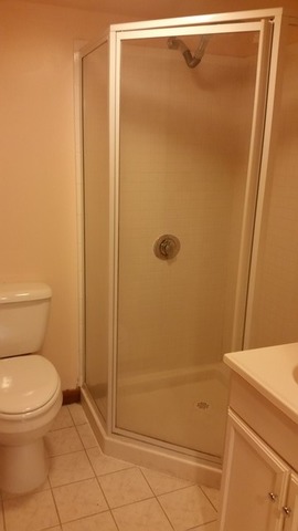 828 South May Street Chicago, IL 60607 - Photo 5 of 9 a bathroom with a granite countertop toilet and a shower