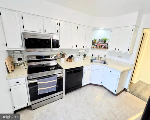 a kitchen with stainless steel appliances white cabinets and a stove