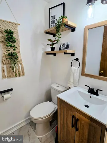 a bathroom with a sink a toilet and mirror