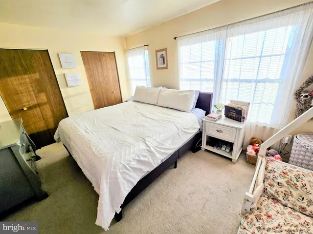 a bed room with a bed and a window