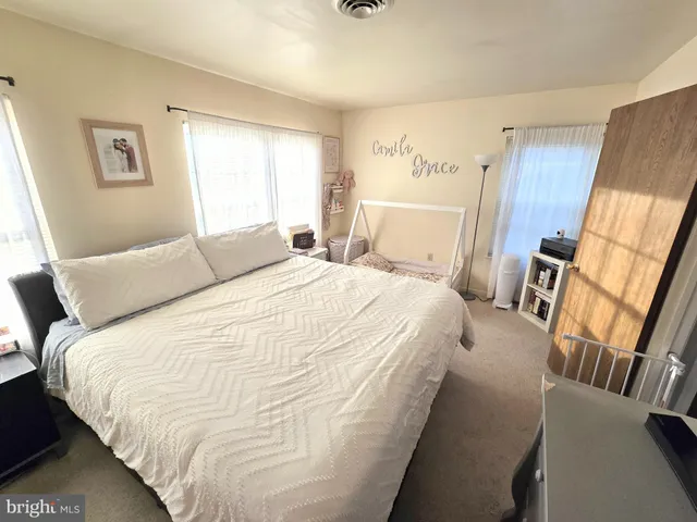 a large white bed in a white room