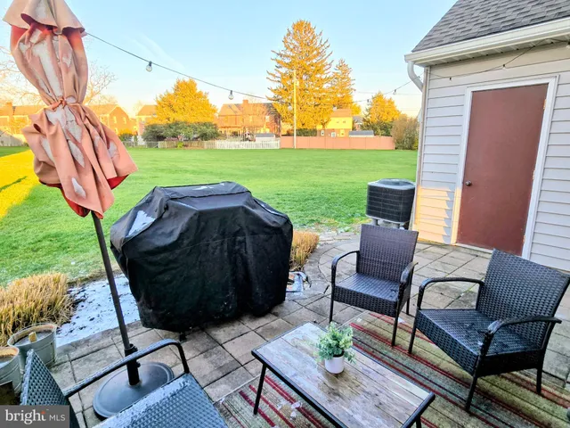 a view of a patio with table and chairs and potted plants