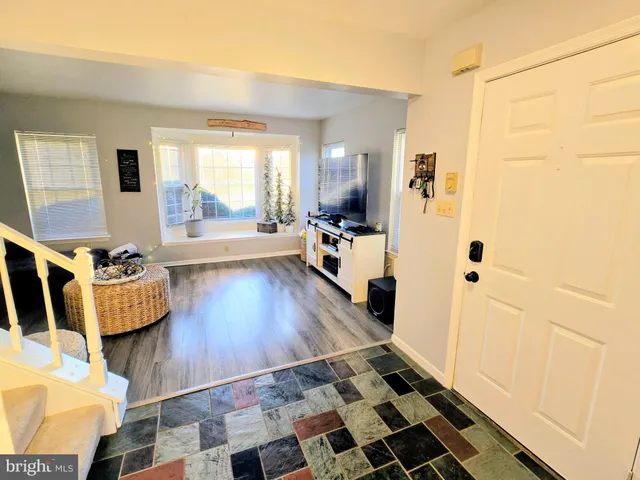 a living room with a rug and a window