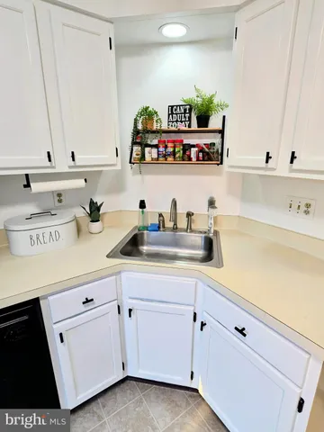 a kitchen with white cabinets and white appliances