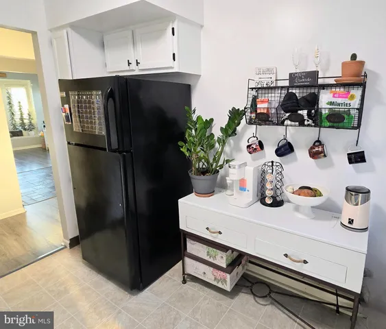 a kitchen with a refrigerator and a stove