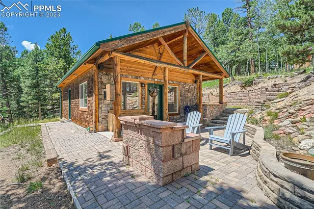 a view of a house with backyard and sitting area