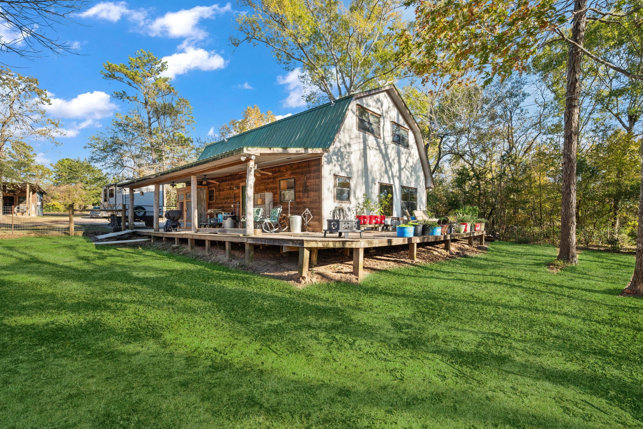 521 Camilla Lake Road Coldspring, TX 77331 - Photo 18 of 34 a view of a swimming pool with lawn chairs and a big yard