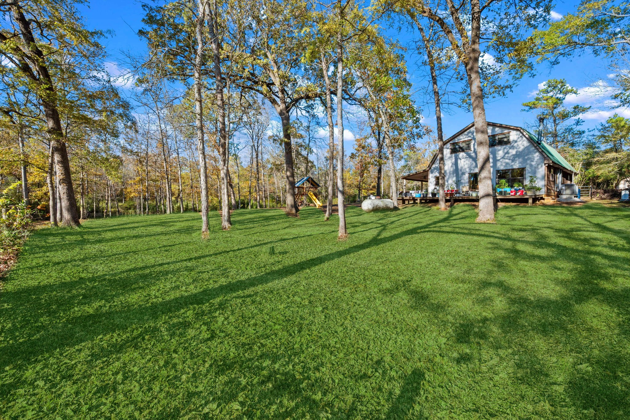 521 Camilla Lake Road Coldspring, TX 77331 - Photo 19 of 34 a front view of a building with a garden