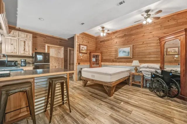 a spacious bedroom with a bed a table and chairs