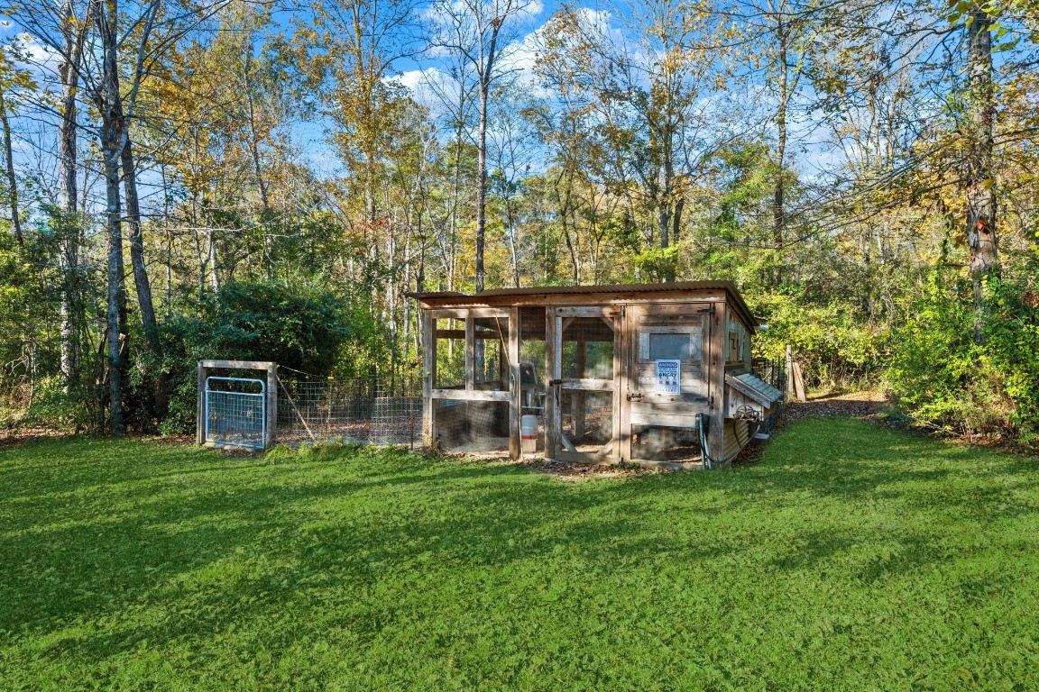 521 Camilla Lake Road Coldspring, TX 77331 - Photo 33 of 34 a view of a house with backyard porch and sitting area