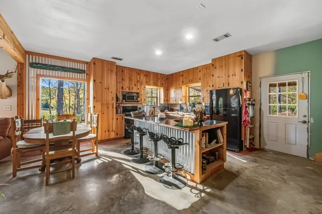a view of kitchen with furniture and windows