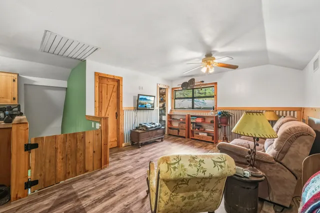 a living room with furniture and a wooden floor
