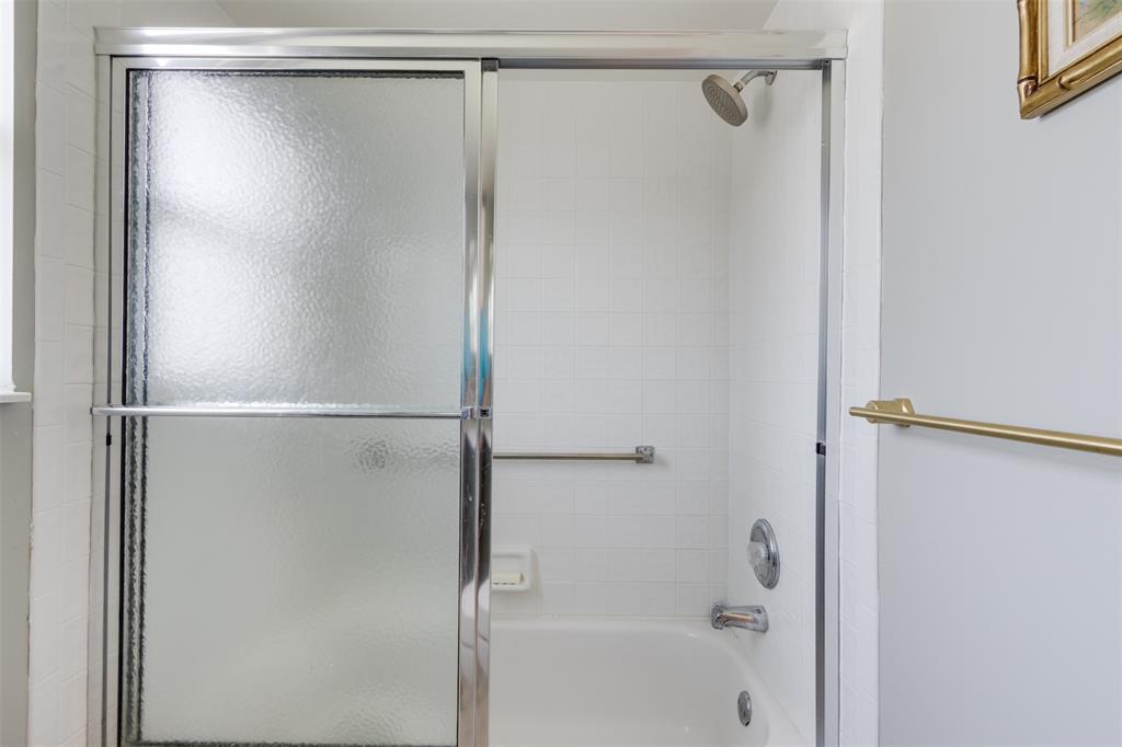 9539 Weldon Circle, Unit F201 Tamarac, FL 33321 - Photo 18 of 33 a bathroom with a glass shower door