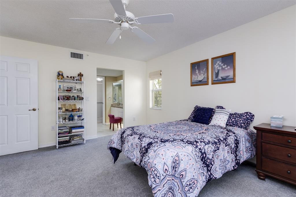 9539 Weldon Circle, Unit F201 Tamarac, FL 33321 - Photo 19 of 33 a bedroom with a bed and a closet