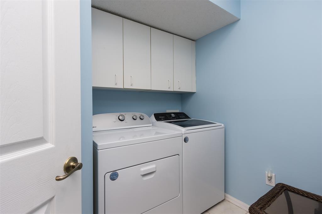 9539 Weldon Circle, Unit F201 Tamarac, FL 33321 - Photo 23 of 33 a view of storage and utility room with washer and dryer