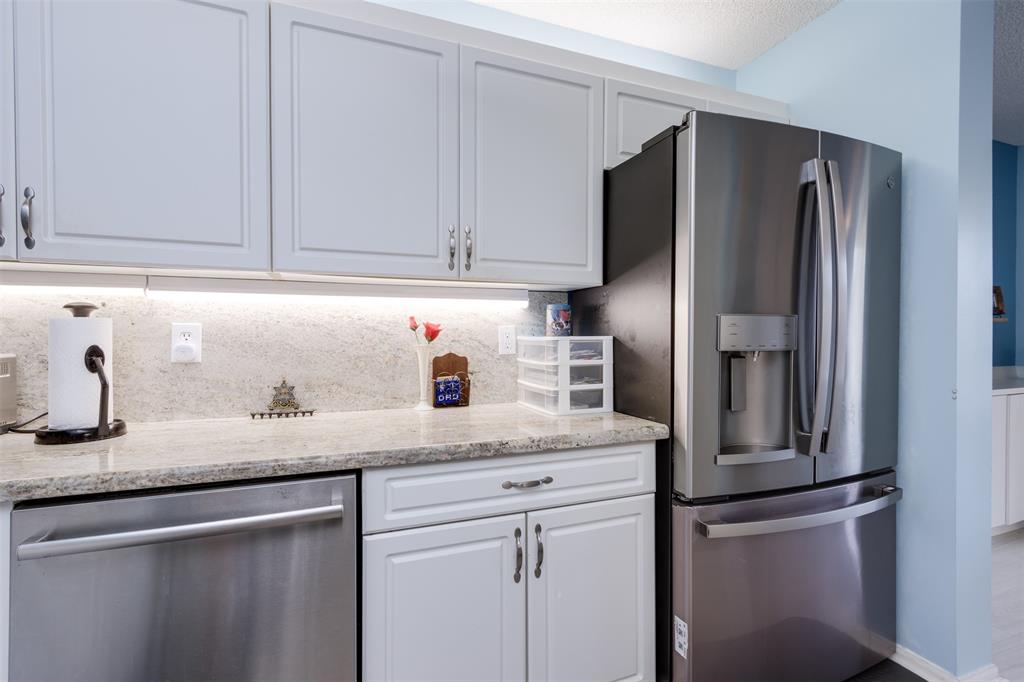 9539 Weldon Circle, Unit F201 Tamarac, FL 33321 - Photo 4 of 33 a kitchen with stainless steel appliances granite countertop a refrigerator a sink and dishwasher