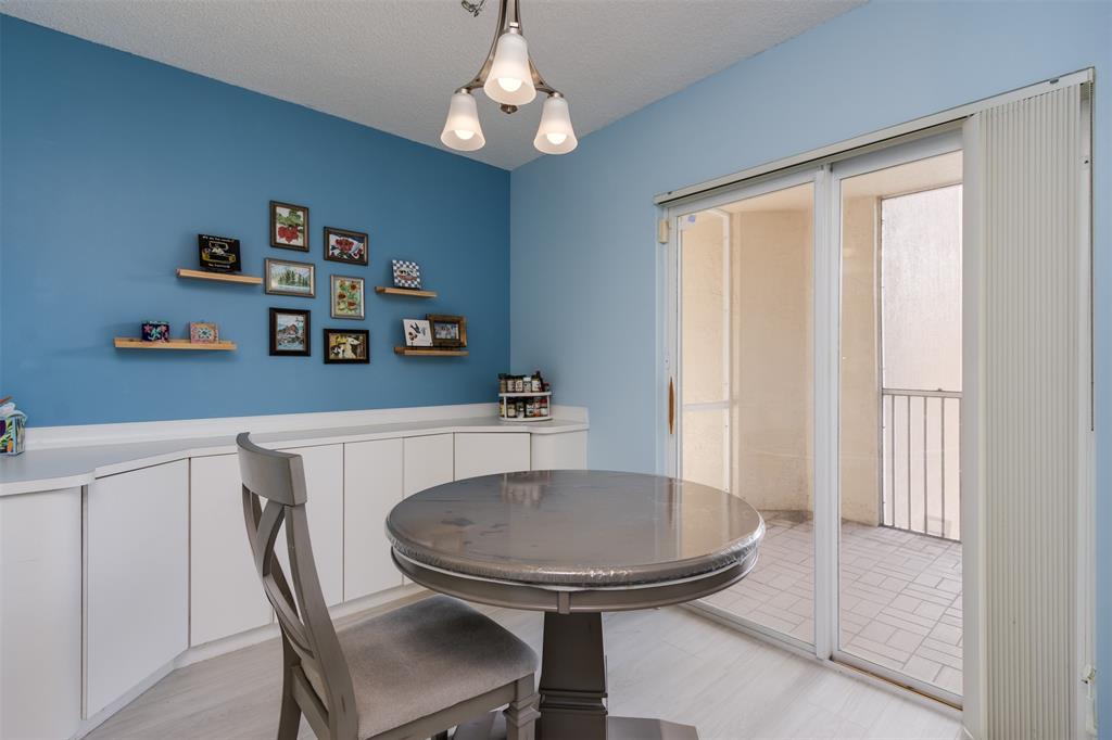 9539 Weldon Circle, Unit F201 Tamarac, FL 33321 - Photo 6 of 33 a view of a dining room with furniture and a chandelier