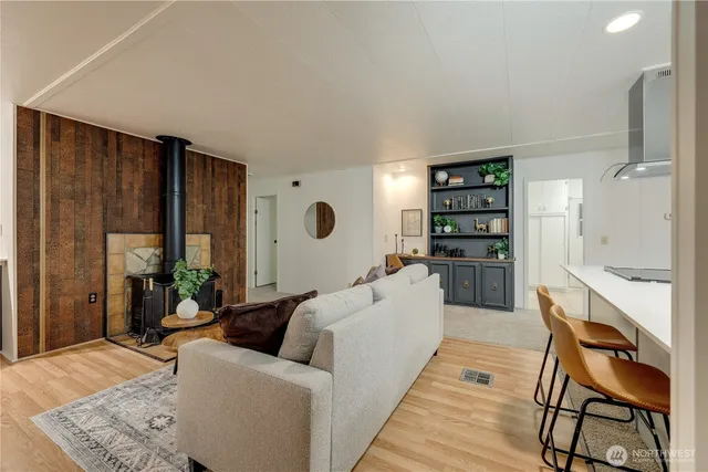 a living room with furniture and a book shelf