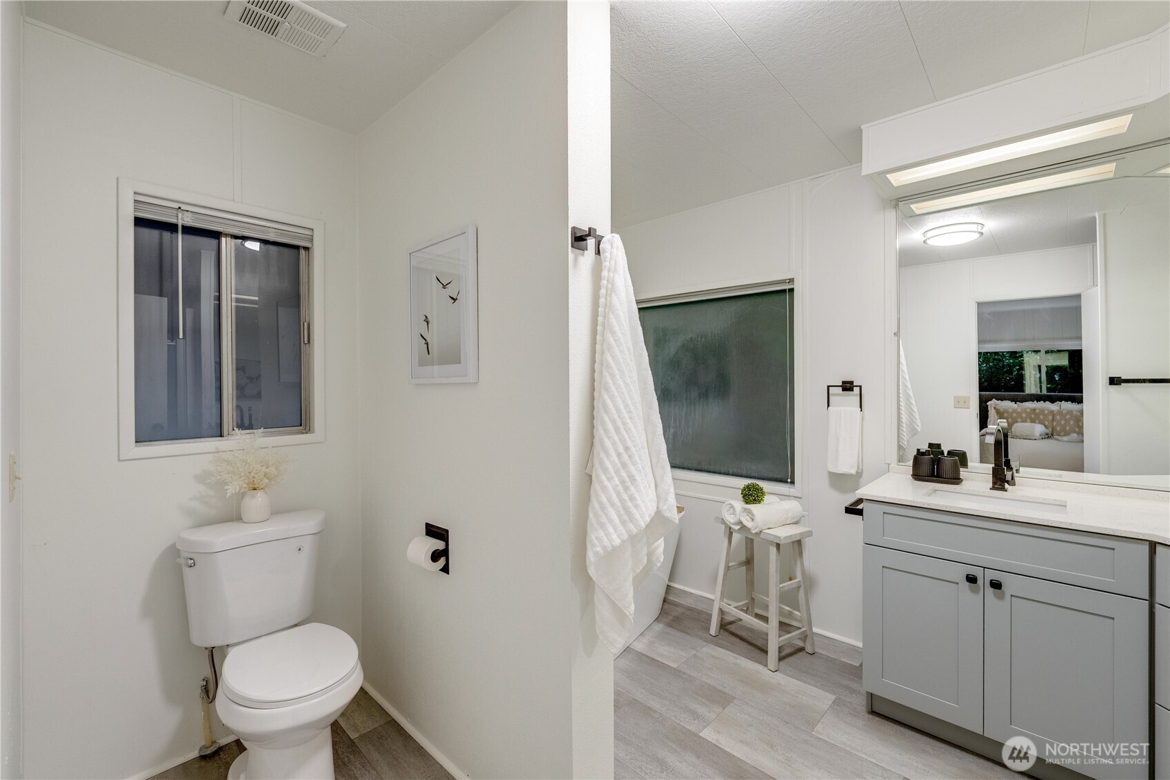 19305 127th Avenue Northeast Bothell, WA 98011 - Photo 25 of 38 a bathroom with a toilet sink and mirror
