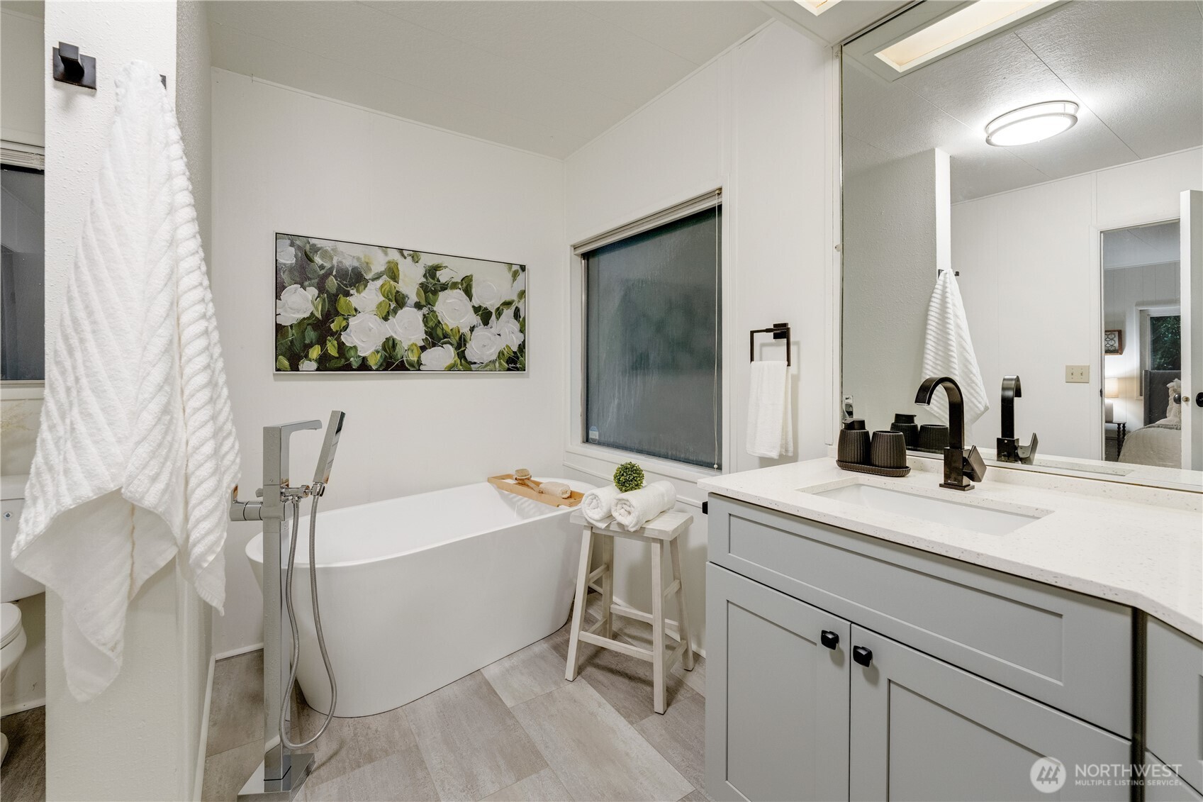 19305 127th Avenue Northeast Bothell, WA 98011 - Photo 27 of 38 a bathroom with a sink mirror and a bathtub