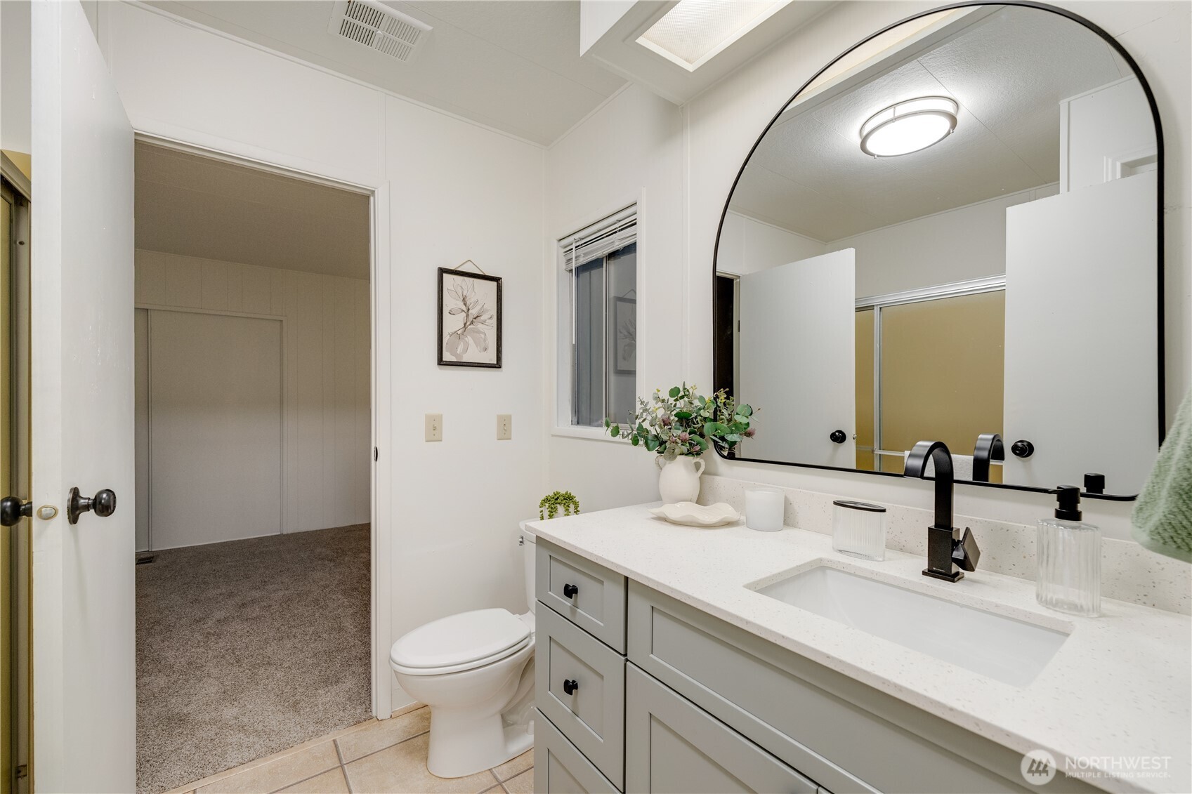 19305 127th Avenue Northeast Bothell, WA 98011 - Photo 36 of 38 a bathroom with a sink a toilet and a mirror