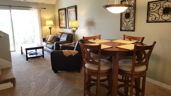 a dining room with furniture and window