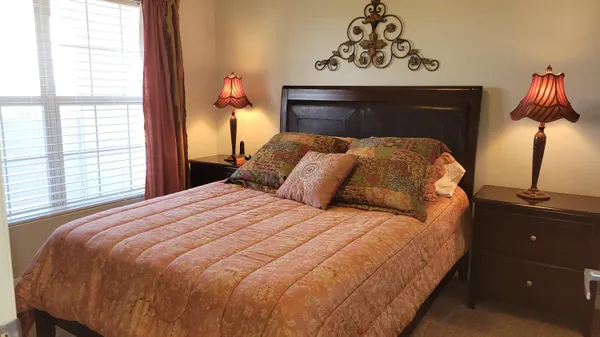 a bedroom with a bed and a window