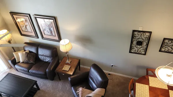 a living room with furniture and a lamp