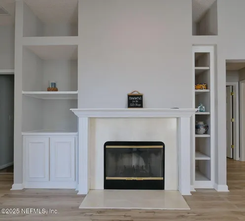 a kitchen with stainless steel appliances granite countertop a sink a stove and a window with wooden floor