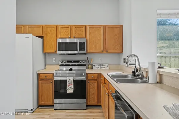 a kitchen with a refrigerator and a sink