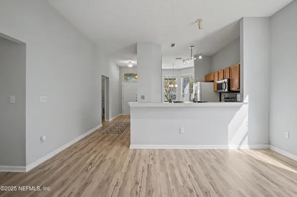 a living room with furniture fireplace and a large window