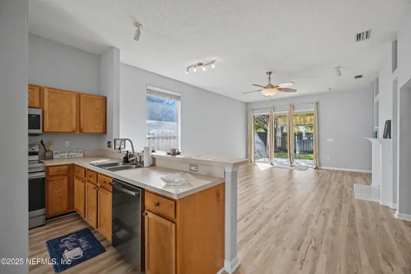 a spacious bedroom with a bed a couch and a flat screen tv
