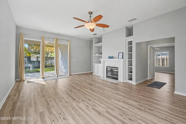 a spacious bedroom with a bed a couch and a flat screen tv
