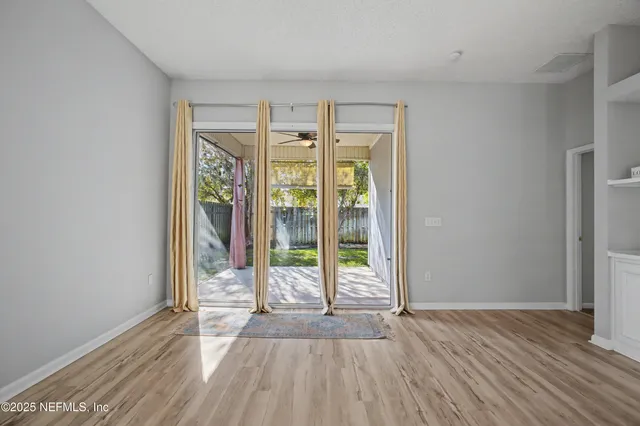 a view of a livingroom with a window and a ceiling fan