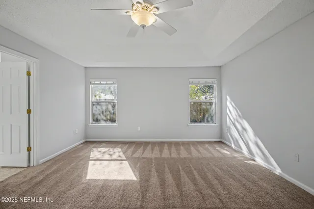 a view of a livingroom with wooden floor and a fireplace