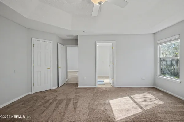 a view of a hallway with wooden floor and a hallway