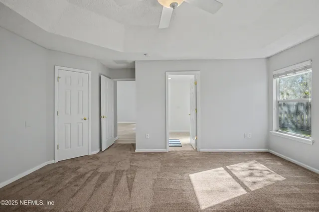 a view of a hallway with wooden floor and a hallway