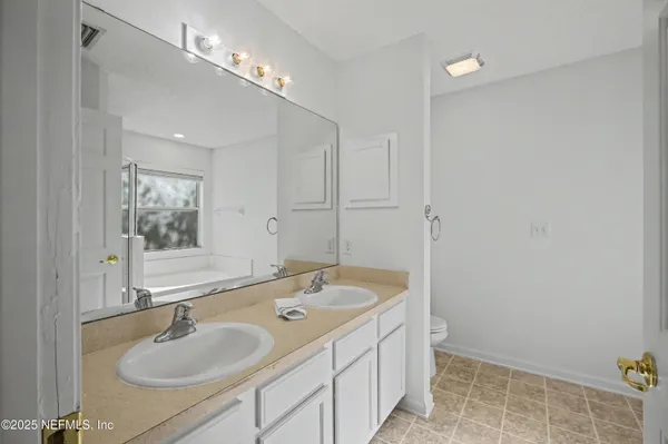 a living room with furniture and a book shelf