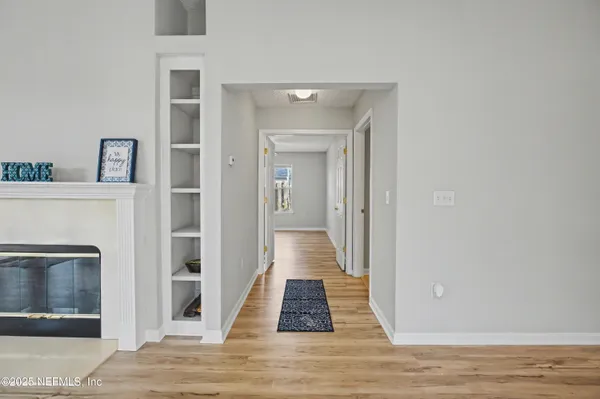 a view of a hallway with wooden shelves