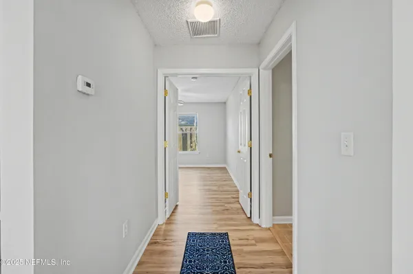 a view of a bathroom from a corridor