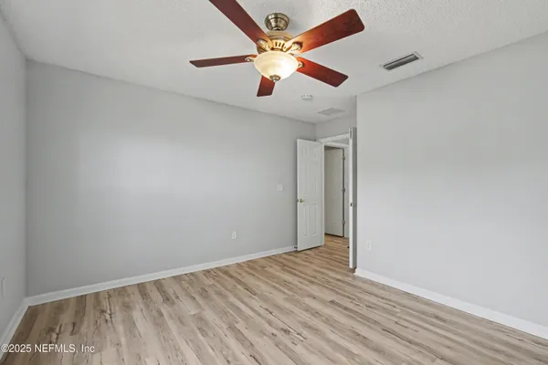 an empty room with windows and closet