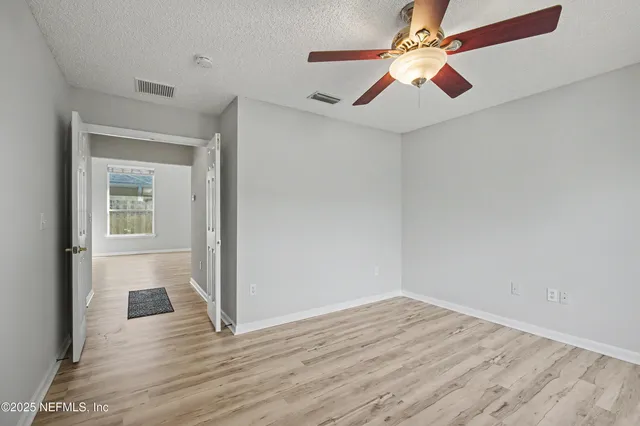 an empty room with windows and closet