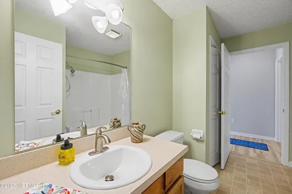 a bedroom with a balcony a bed and a chandelier