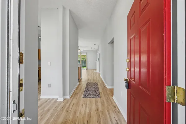 a living room with a fireplace and a shelf