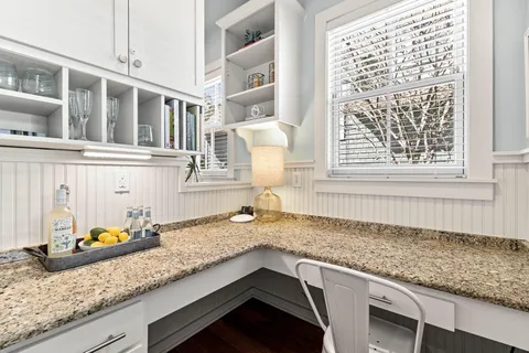 a kitchen with granite countertop a sink and a window